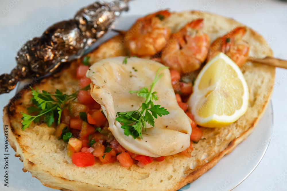 Italian food. Bruschetta with grilled squid, tomato salsa