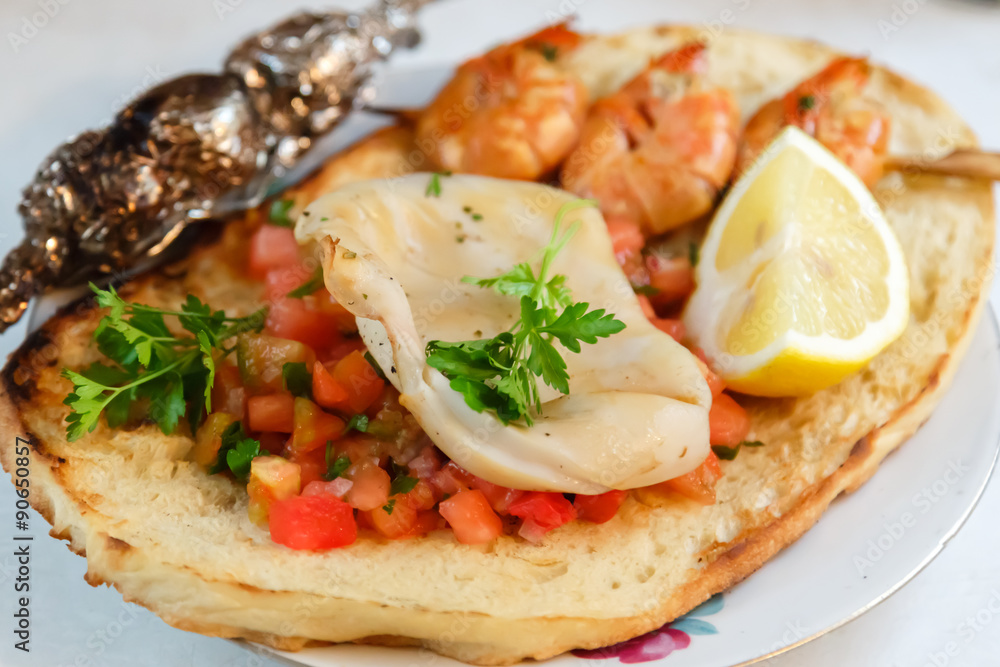 Grilled shrimp and squid on bruschetta