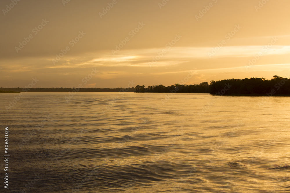 Colorful sunset on the river Amazon in the rainforest, Brazil