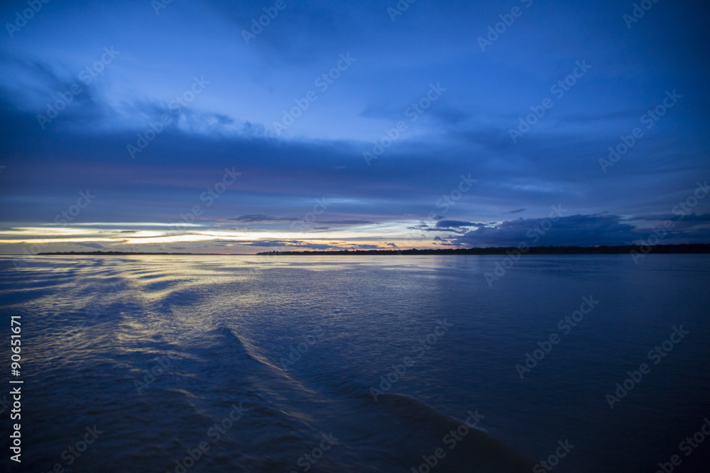 Fototapeta premium Colorful sunset on the river Amazon in the rainforest, Brazil