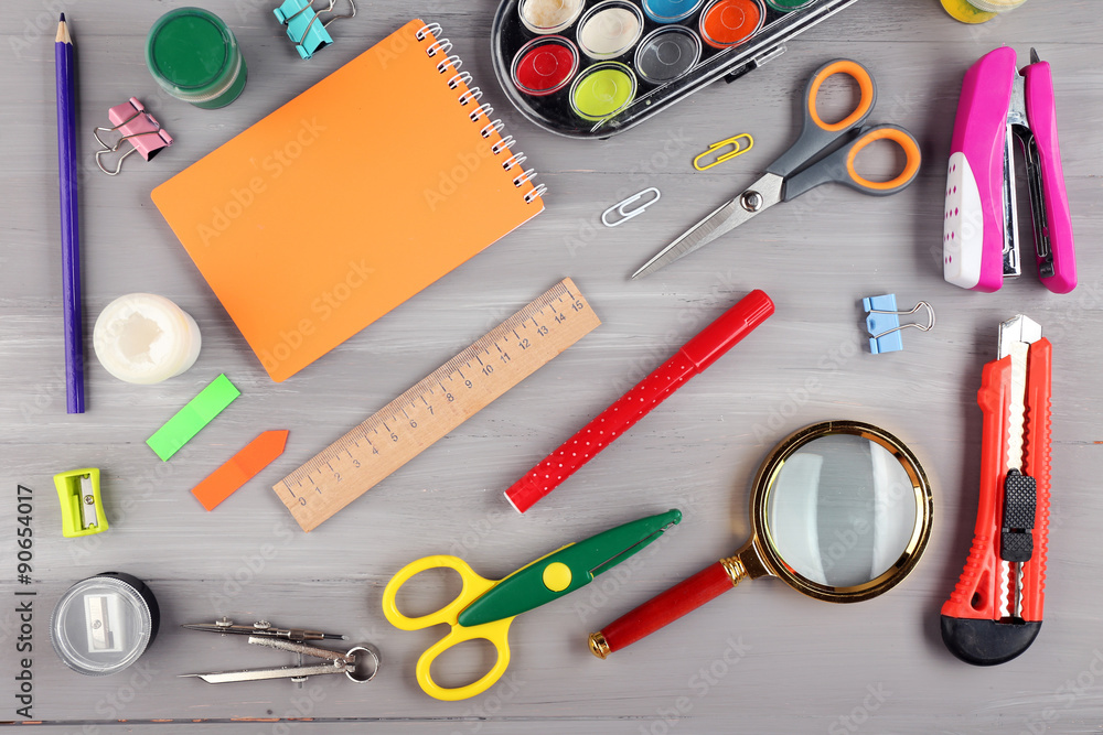 Bright stationery objects on wooden table close up