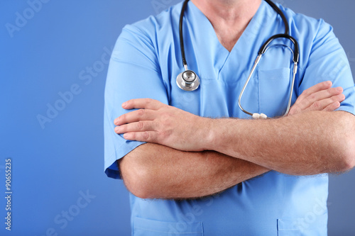 Doctor with stethoscope on colorful background