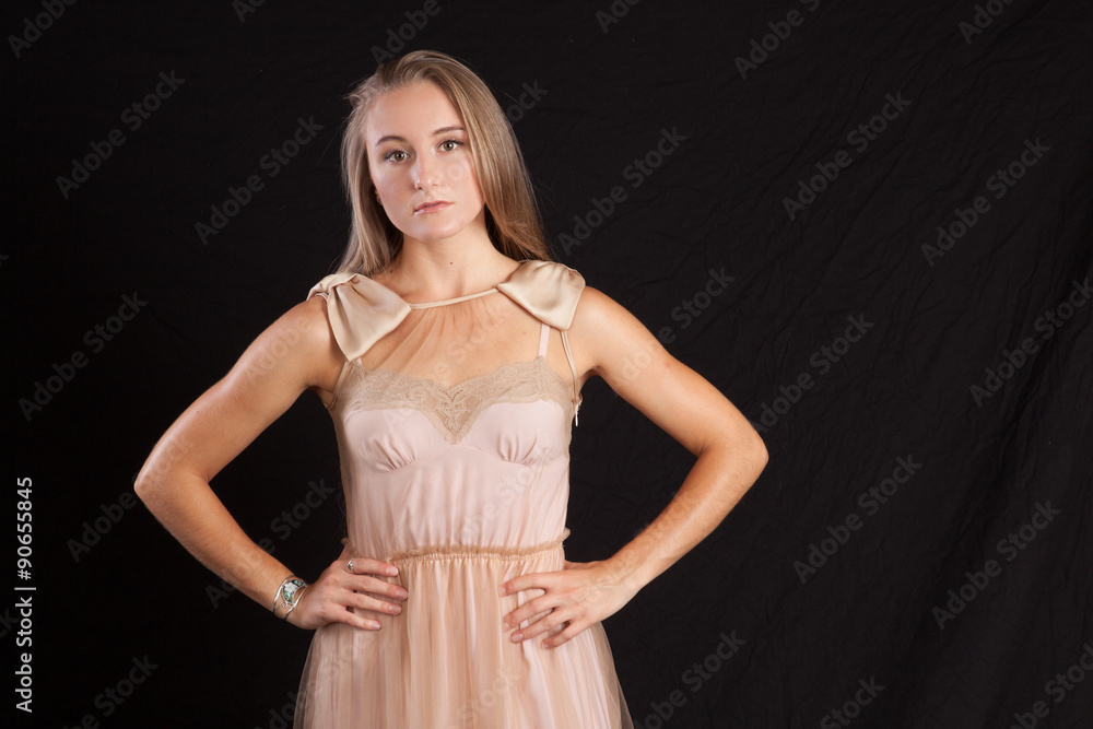 Pretty woman with long hair, looking thoughtful with her hand on her hip Pretty woman with long hair, looking thoughtful with her hand on her hip