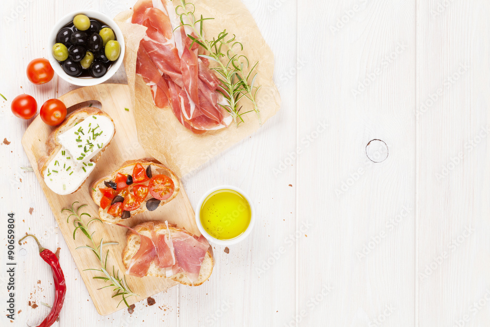 Bruschetta with cheese, tomatoes and prosciutto Bruschetta with cheese, tomatoes and prosciutto