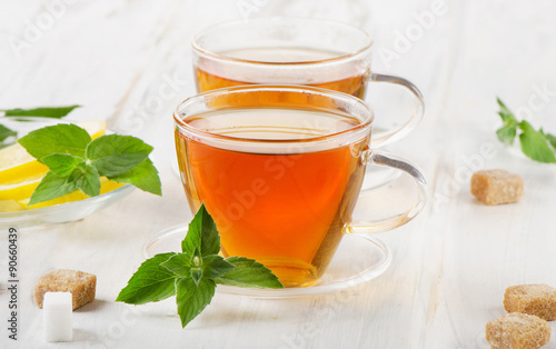 Tea cup with mint and lemon slices.