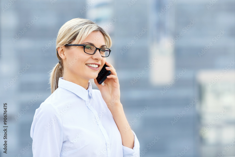 Young business woman talking on phone. 
