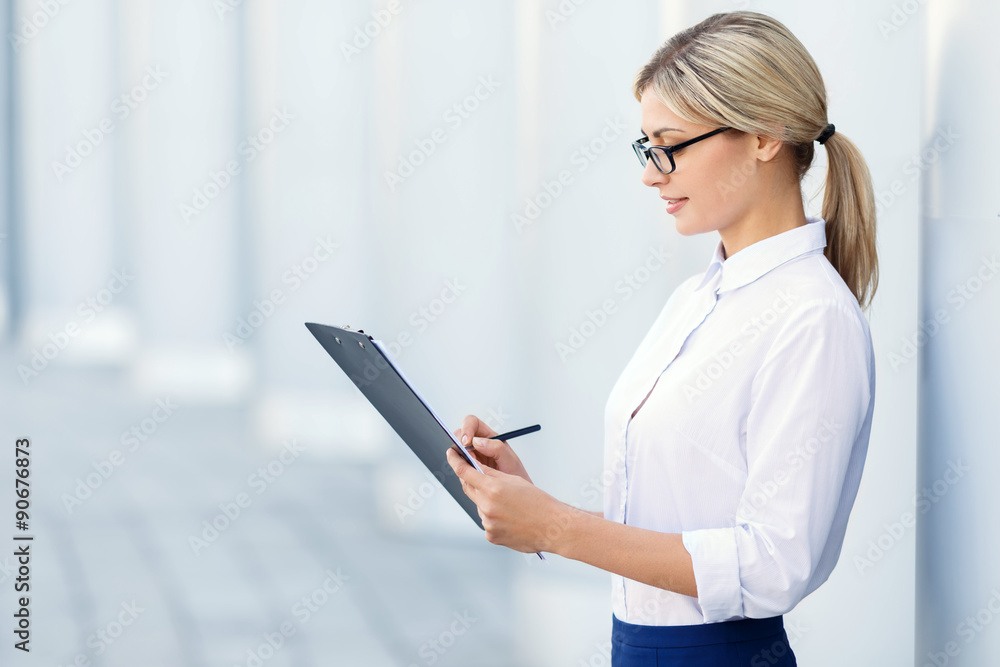 Cheerful business woman holding folder 