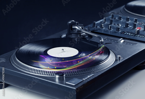 Turntable playing vinyl with glowing abstract lines