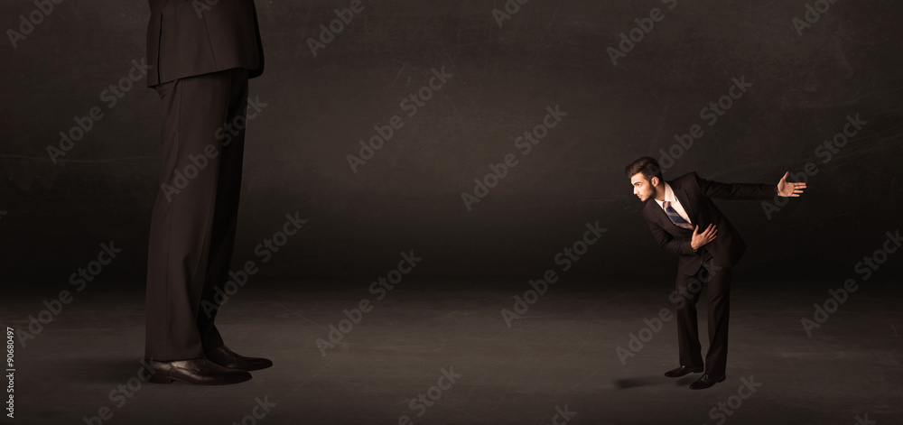 Fototapeta premium Huge man with small businessman standing at front concept