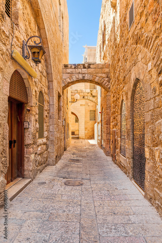 Narrow street among old stone walls of Jewish Quarter in Jerusal