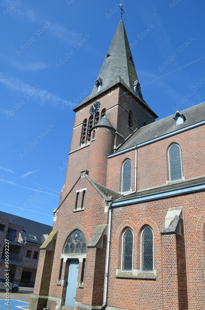 Brick church tower against blue sky