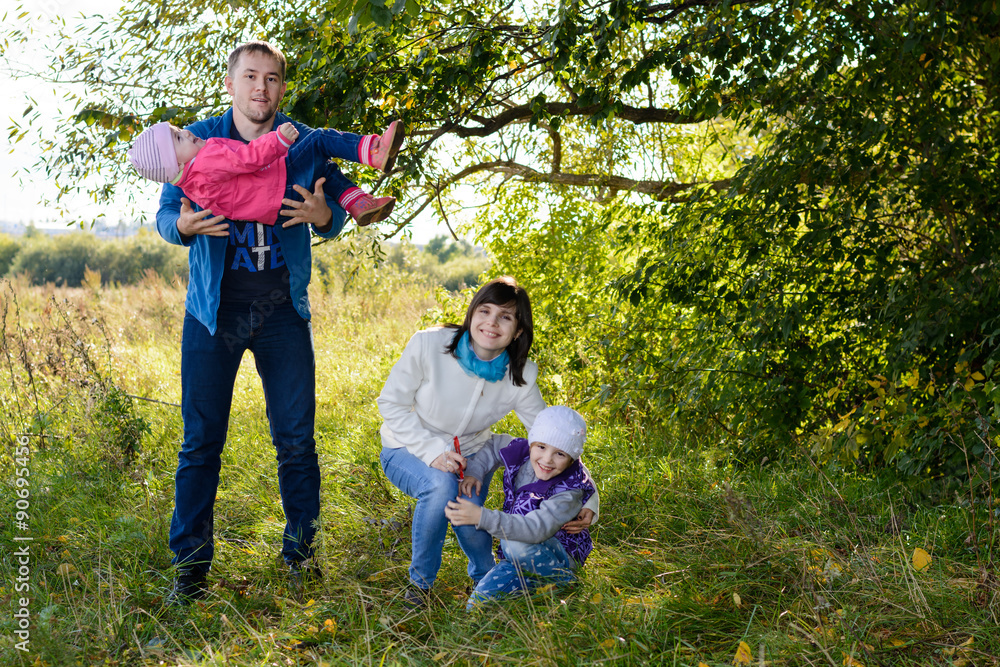 Fototapeta premium Family resting the meadow in autumn