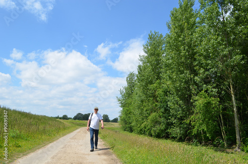 Man walking on a trail in the countryside