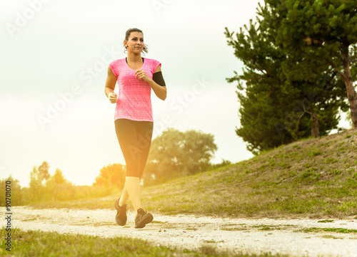 Woman Running In Countryside at beautiful sunset.