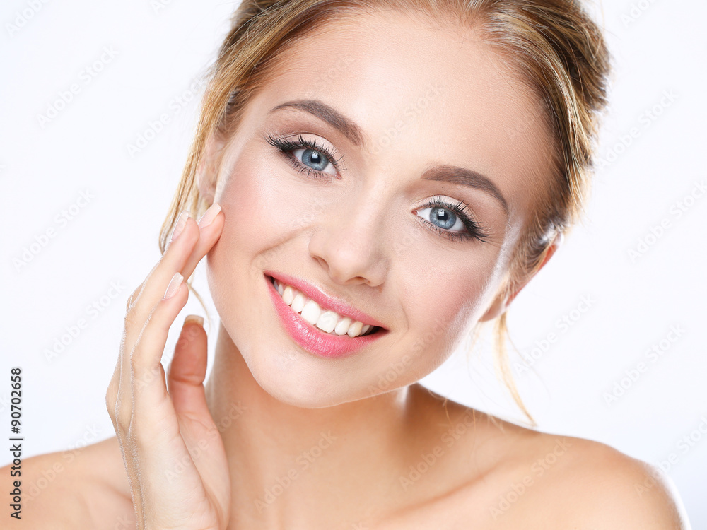 Young woman touching her face isolated on white background Young woman touching her face isolated on white background