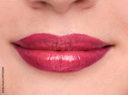 Closeup portrait of young woman's lips zone make up