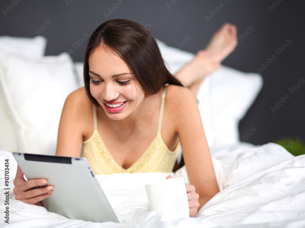 Women use a tablet pc on the bed Women use a tablet pc on the bed