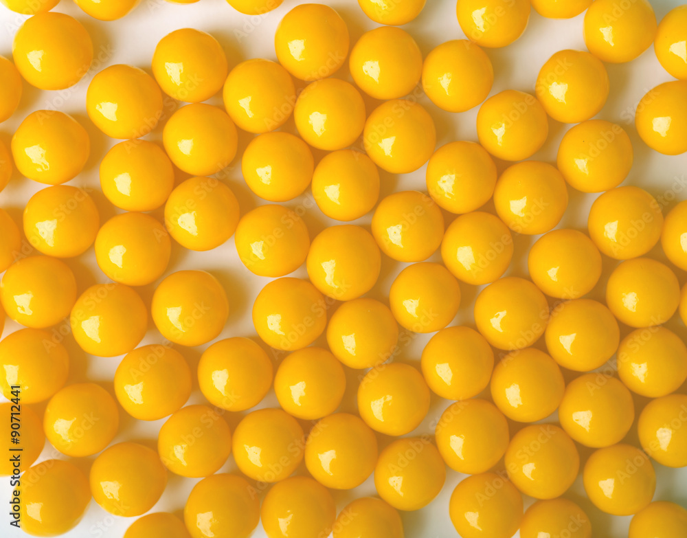 Yellow round pills, as vitamins on white background. Yellow round pills, as vitamins on white background.