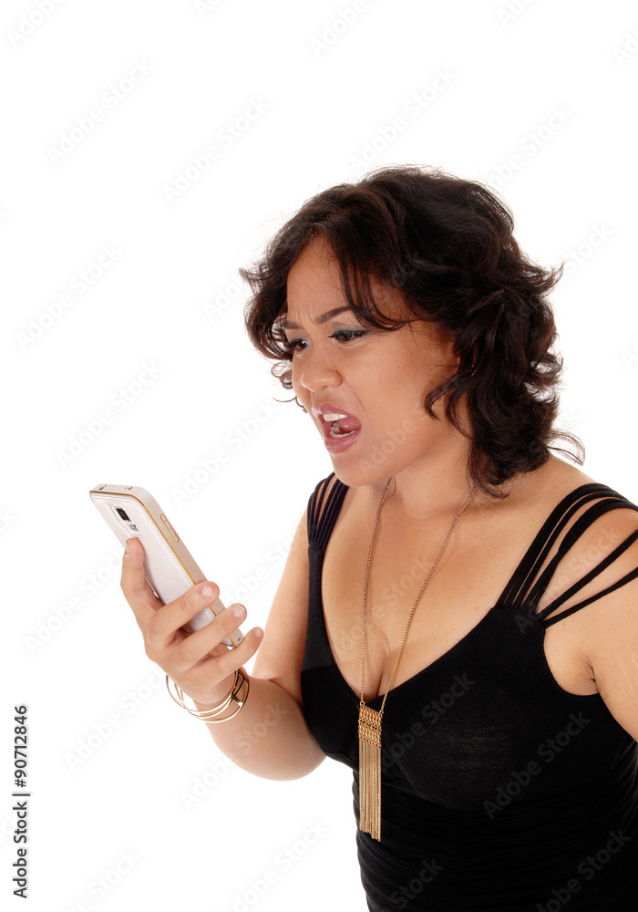 Young woman shouting at her cell phone. Young woman shouting at her cell phone.
