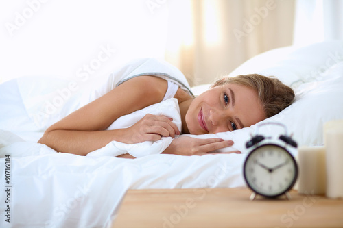 Woman can not sleep.Clock on the desk