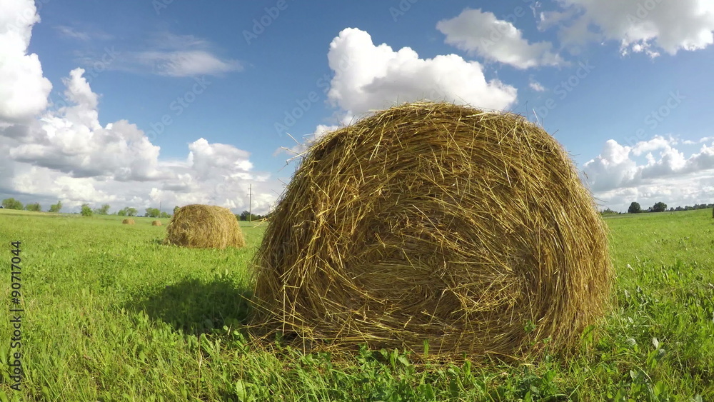 Haystacks in the field on cloudy day, timelapse 4K Haystacks in the field on cloudy day, timelapse 4K