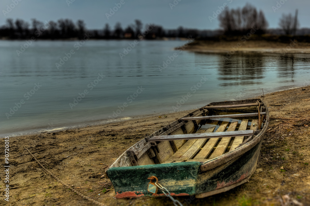 Old boat in the river shore