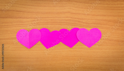 pink heart on wood background.