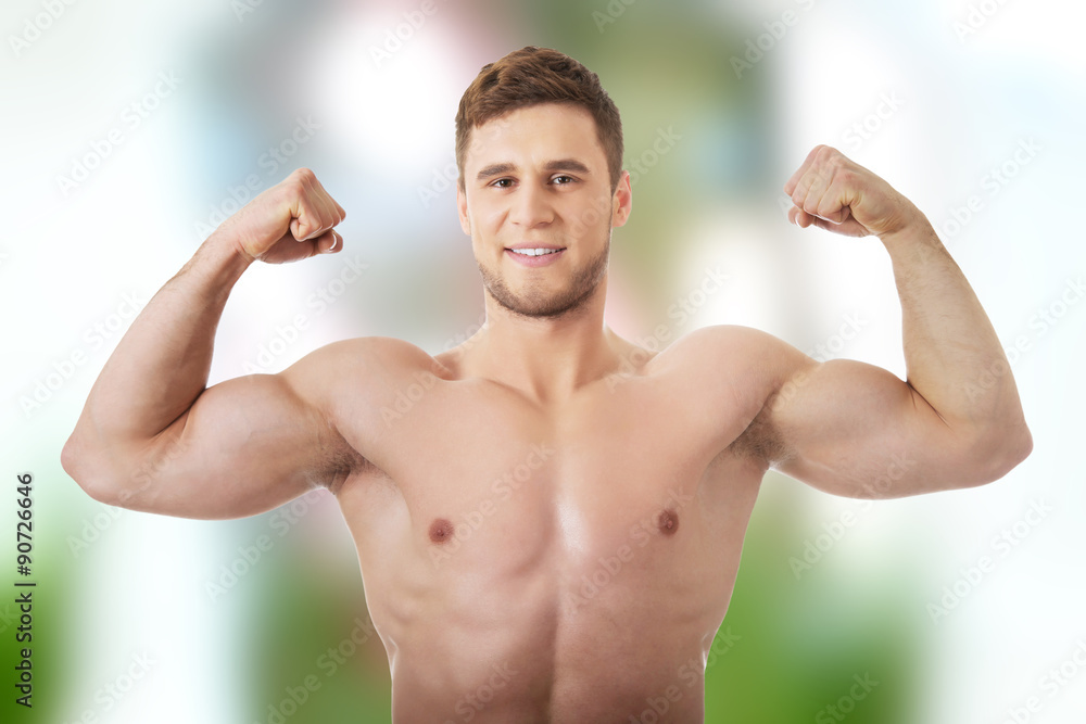 Young athletic man showing his muscles. Young athletic man showing his muscles.