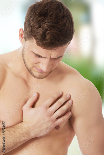 Athletic man feeling pain in his chest.