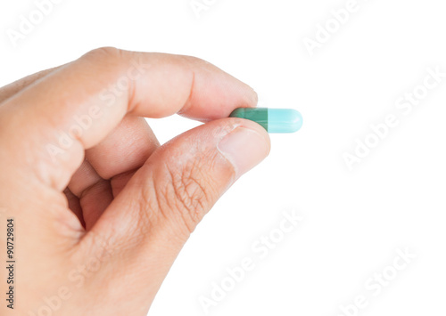 pill in male hand on white background isolated