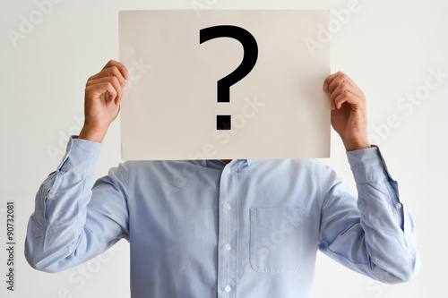 Employee dilemma with question marks on blank paper photo