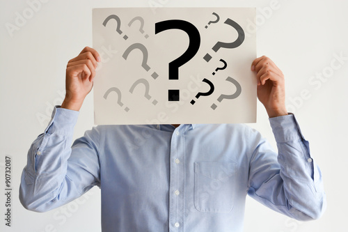 Employee dilemma with question marks on blank paper