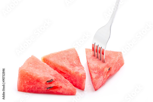 Pieces of watermelon with fork isolated on white background.