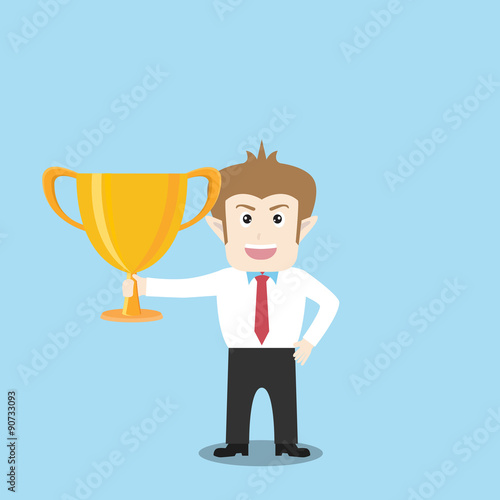 Businessman holding trophy