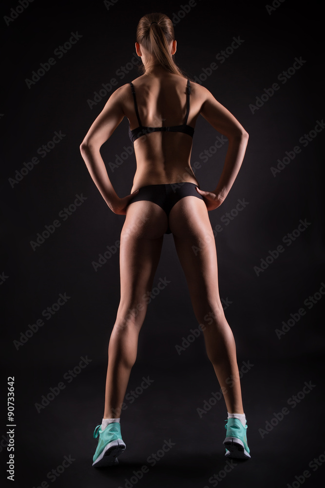 Sporty female model against black background Sporty female model against black background