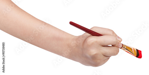 hand with artistic flat paintbrush paints in red