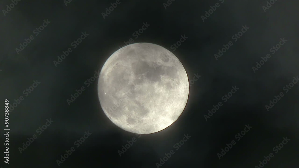 A realtime shot of the full moon on a cloudy night. Not computer generated. A realtime shot of the full moon on a cloudy night. Not computer generated.
