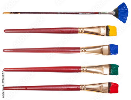 set of flat artistic paintbrushes with painted tips photo