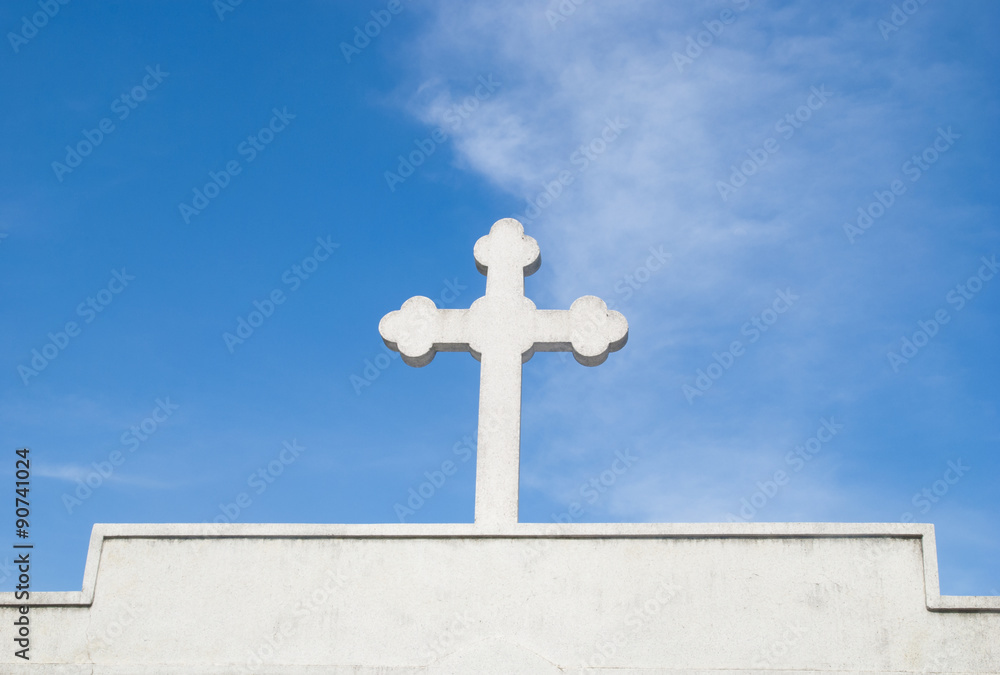 Cross tomb on blue sky background