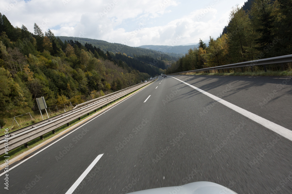 Fototapeta premium Road, green meadows, blue sky