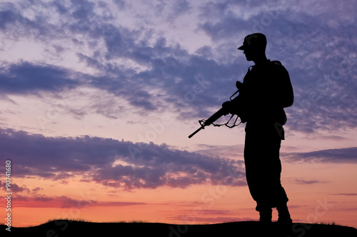 Silhouette of soldier with a gun