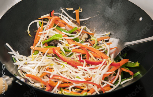 Stir frying vegetables in a wok