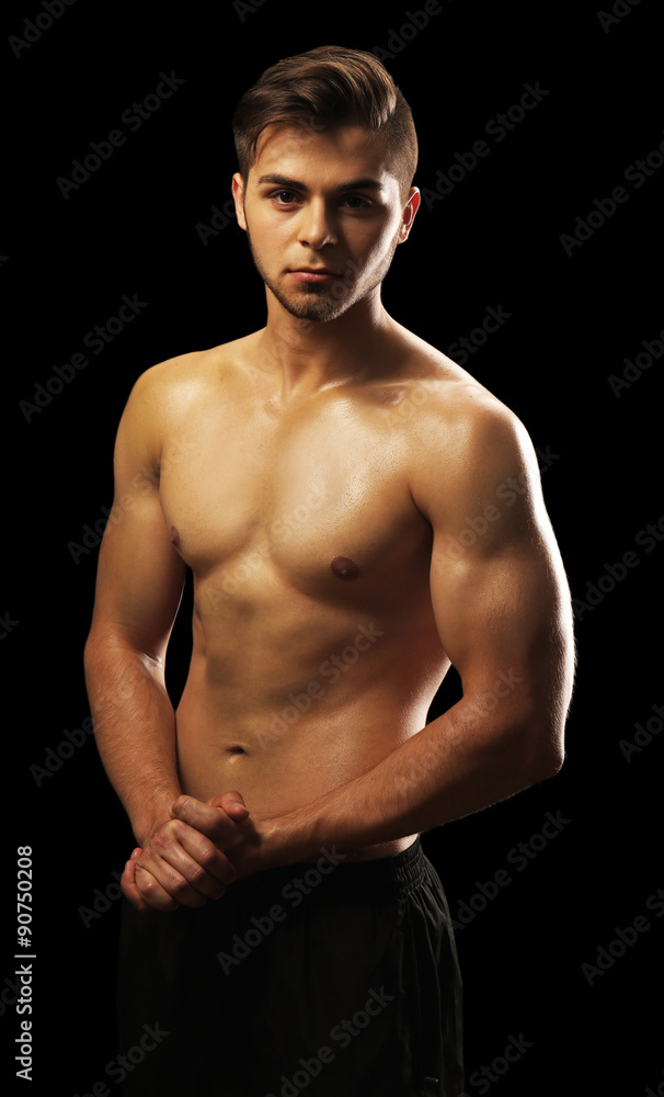 Fototapeta premium Muscle young man on dark background