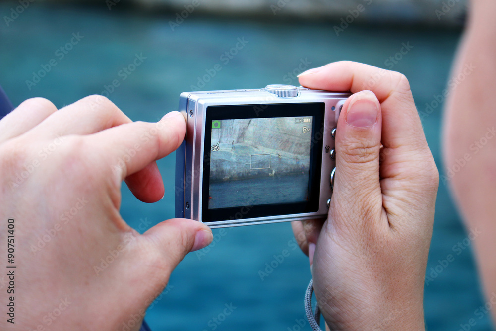 Woman makes photo with camera on the holiday Woman makes photo with camera on the holiday