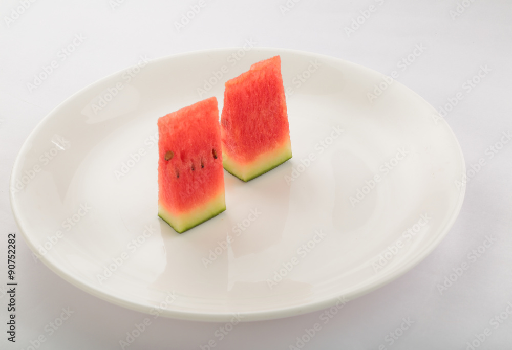 Two Slices of watermelon inWhite plate on white background