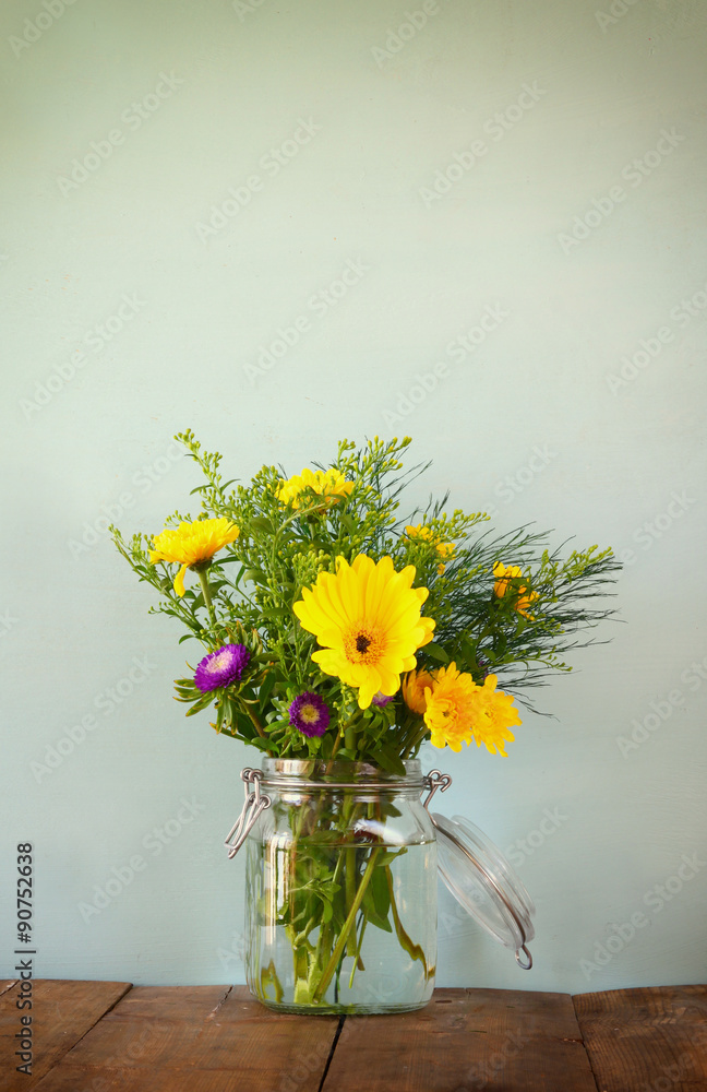summer bouquet of flowers on the wooden table with mint background summer bouquet of flowers on the wooden table with mint background