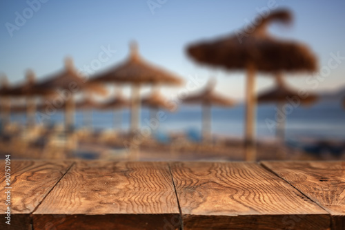 wooden table and Empty beach on background