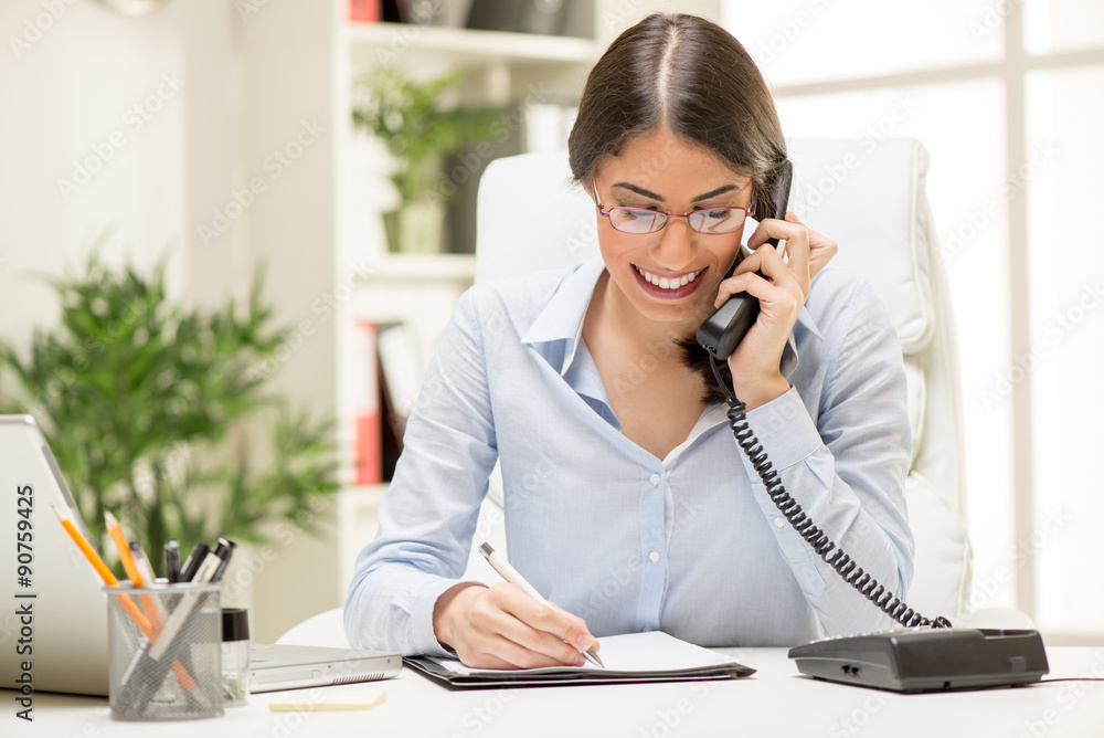 Businesswoman Phoning In The Office