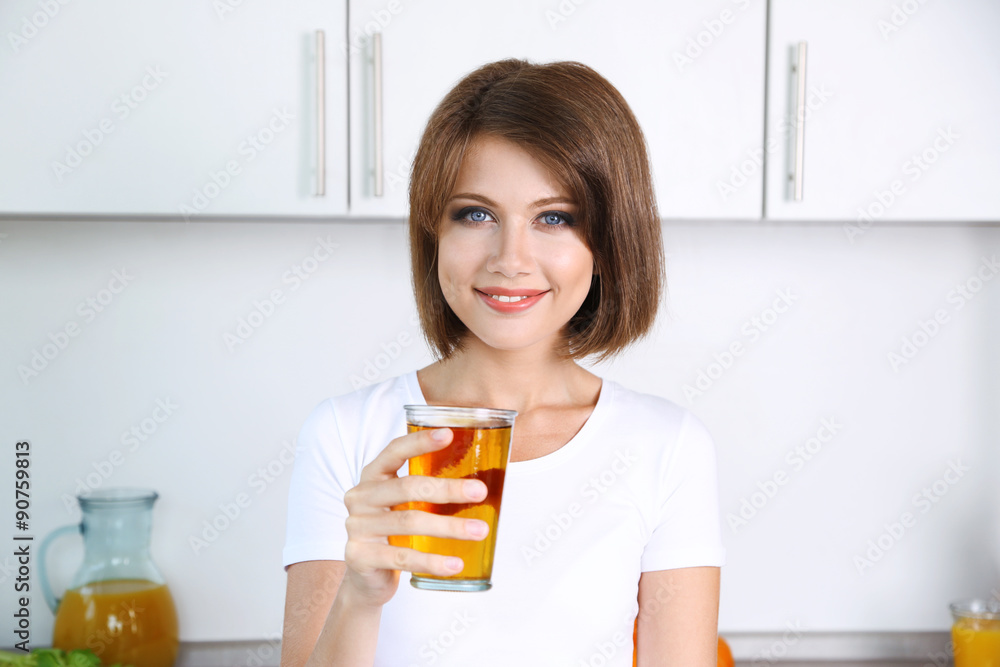 Young beautiful woman showing glass of apple juice Young beautiful woman showing glass of apple juice