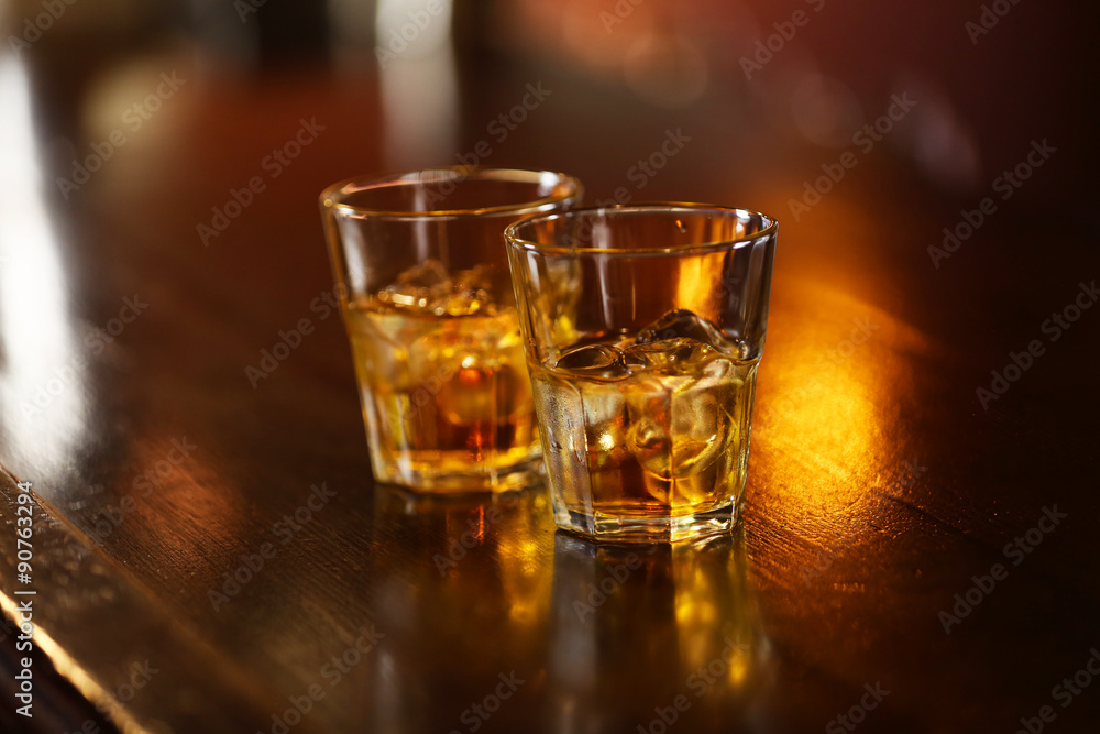 Whiskey glass tumbler standing on bar counter Whiskey glass tumbler standing on bar counter